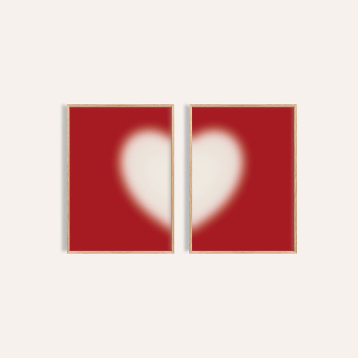 Heart wall art set of 2 with a soft cream heart split across two cherry red prints