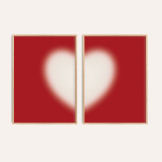 Heart wall art set of 2 with a soft cream heart split across two cherry red prints