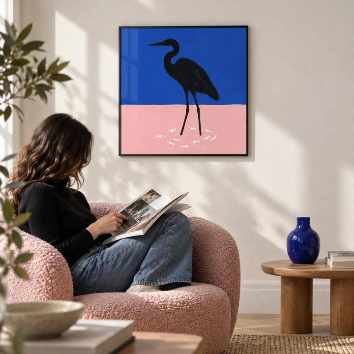 Heron Art Print, framed on the wall of a modern living room with a white wall