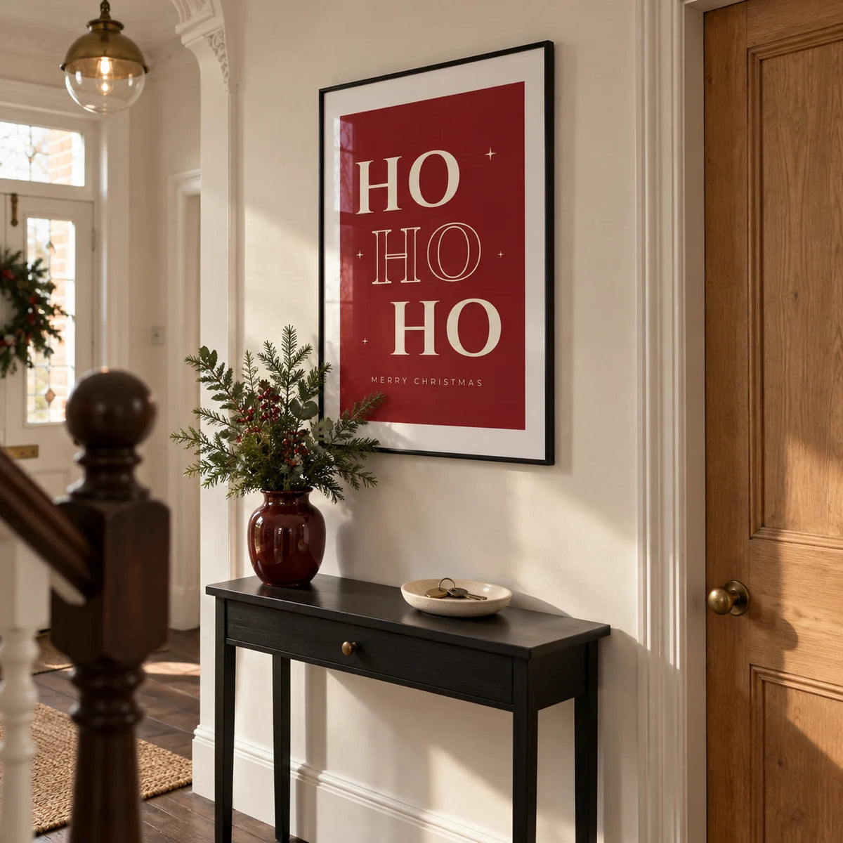 Ho Ho Ho Print, framed on the wall of a crisp entrance hallway in a Victorian UK terrace with warm white walls and dark timber floorboards