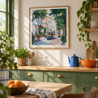 Holiday Prints, framed on the wall of a bright kitchen with leaf green painted cabinets and a pale oak worktop
