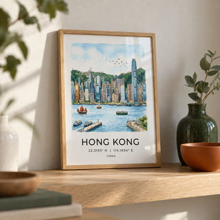 Hong Kong Skyline Art Print, a small A4 framed print leaning on a pale oak shelf in a living room