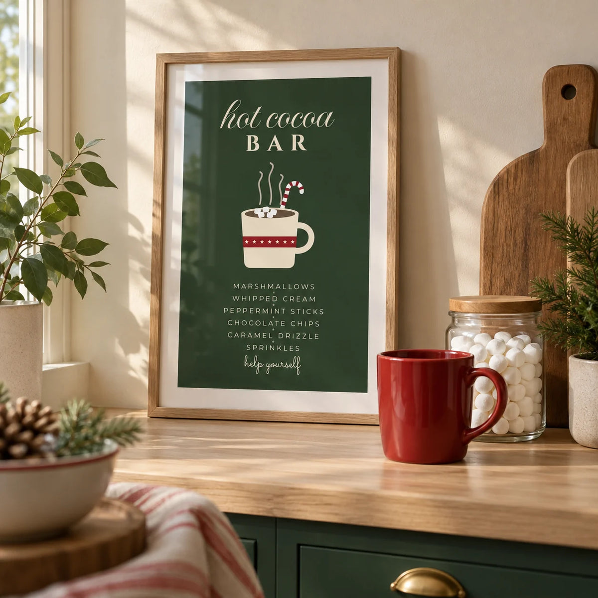 Hot Cocoa Bar Print, a small A4 framed print leaning on a pale oak kitchen worktop