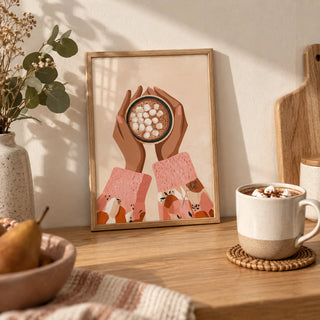 Hot Cocoa Wall Art, a small A4 framed print leaning on an oak worktop in a kitchen