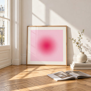 Hot Pink Wall Art, framed and leaning on the parquet floor of a bright living room