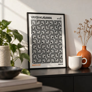 Hypnotic Wall Art, a small A4 framed print leaning on a black shelf in a living room