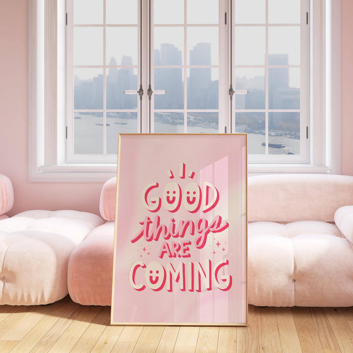 Motivational Posters for Students leaning pink and white typographic print against a sofa and window
