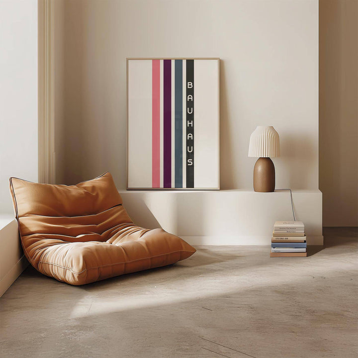 Geometric Art Wall print with vertical colour stripes and text leaning on a low white shelf next to a lamp and chair