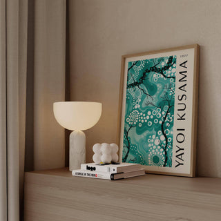 Abstract teal wall decor featuring black branches and vibrant tones