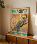 Japanese heritage art poster with a golden sky, peacock, and cherry blossoms.