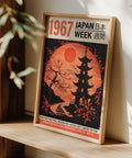 Traditional Japanese woodblock-style art with cherry blossoms and a red moon.