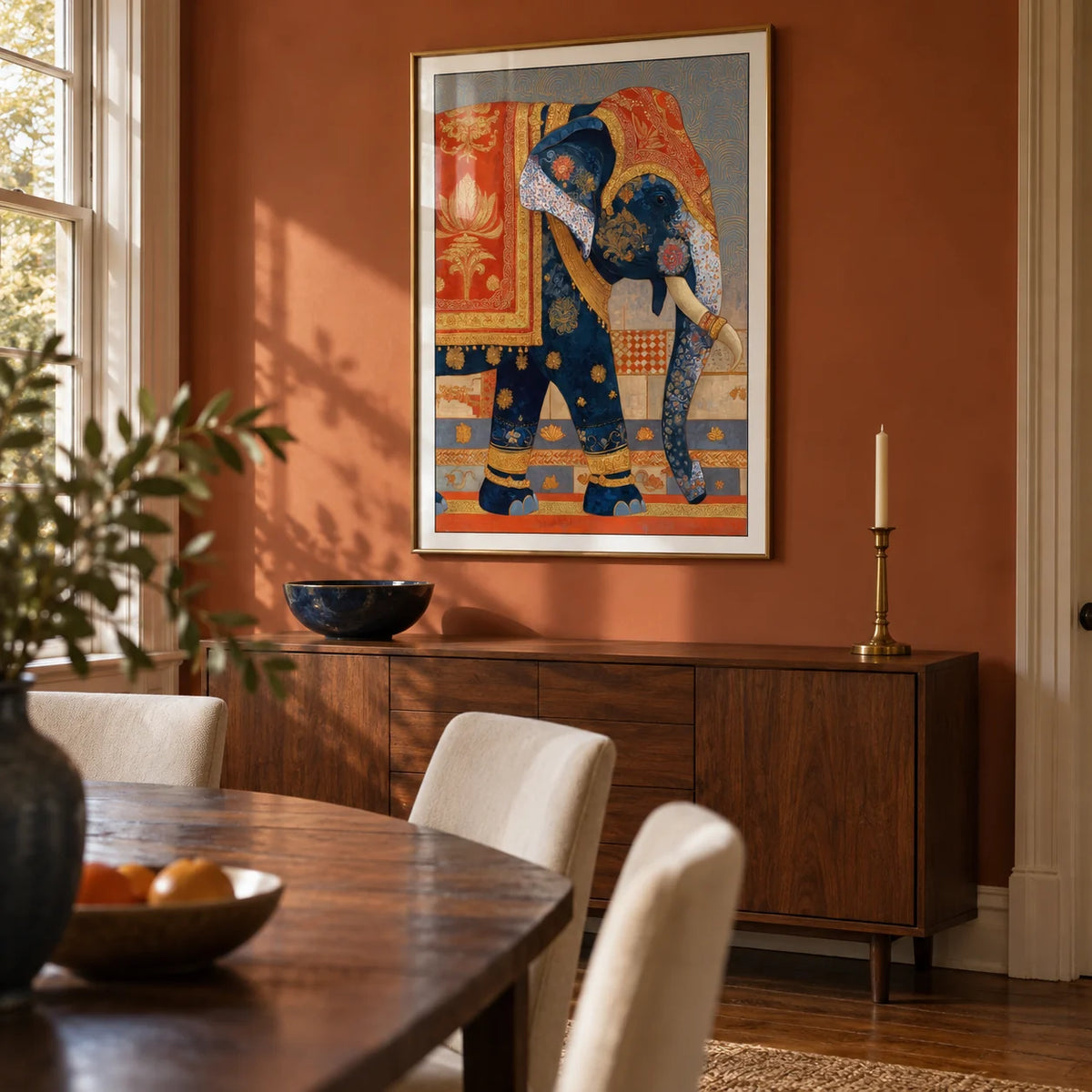 Indian Elephant Print, framed on the wall of a characterful dining room in a British family home with a muted burnt orange wall and oak floorboards