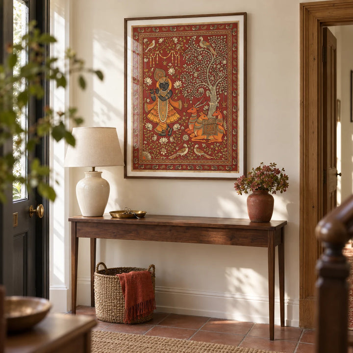 Indian Folk Art Print, framed on the wall of a characterful entrance hallway in a British terrace with pale cream walls and plain terracotta floor tiles