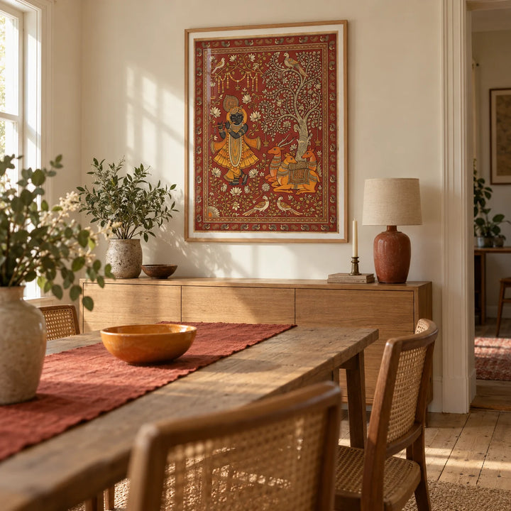 Indian Folk Art Print, framed on the wall of a welcoming dining room in a UK family home with warm ivory walls and stripped timber floorboards