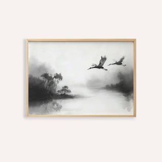 Framed print showing Japanese cranes flying over a misty river in black and grey tones