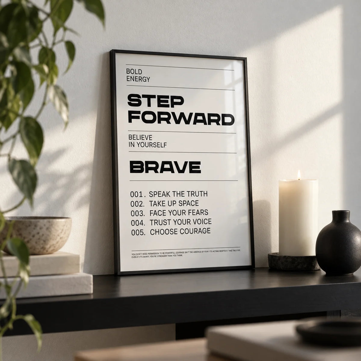 Inspirational Quotes Artwork, a small A4 framed print leaning on a black shelf in a living room
