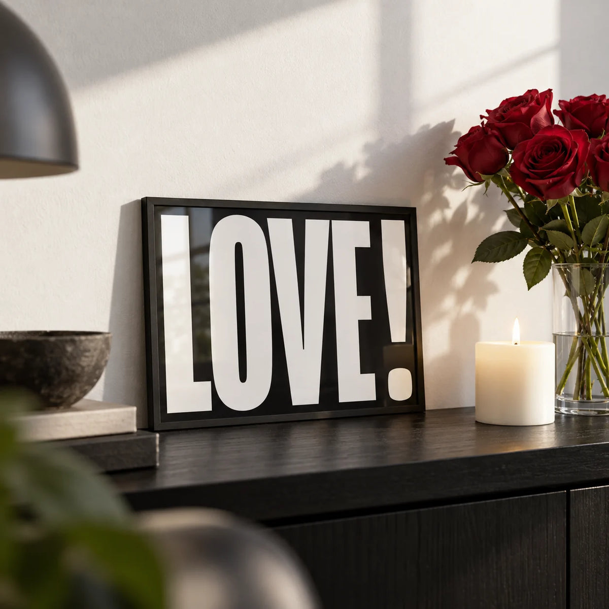 Inspired Posters, a small A4 framed print leaning on a black shelf in a living room