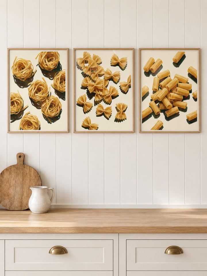 Italian kitchen prints set of 3 hung at eye level above a wooden kitchen worktop: Fettuccine Print, Farfalle Art Print and Rigatoni Pasta Print shown framed side by side (frames not included)