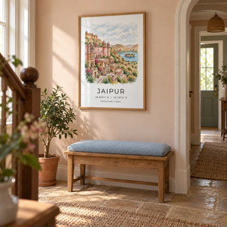 Jaipur Art Print, framed on the wall of a welcoming narrow hallway in a British terraced house with a pale peach plaster wall and warm stone floor