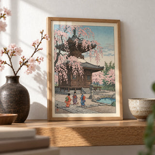 Japanese Cherry Blossom Art Print, a small A4 framed print leaning on an oak shelf in a living room