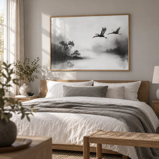 Japanese Cranes Flying Art, framed on the wall of a serene bedroom with a soft grey wall