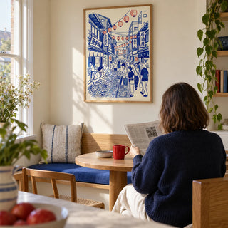 Japanese Street Market Art, framed on the wall of a bright breakfast nook in a UK maisonette with a cream wall and a built-in oak bench in a kitchen