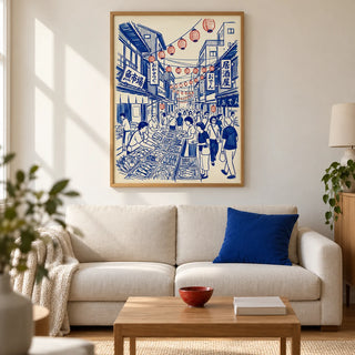 Japanese Street Market Art, framed on the wall of a modern living room in a UK city flat with warm white plaster walls and an oak floor