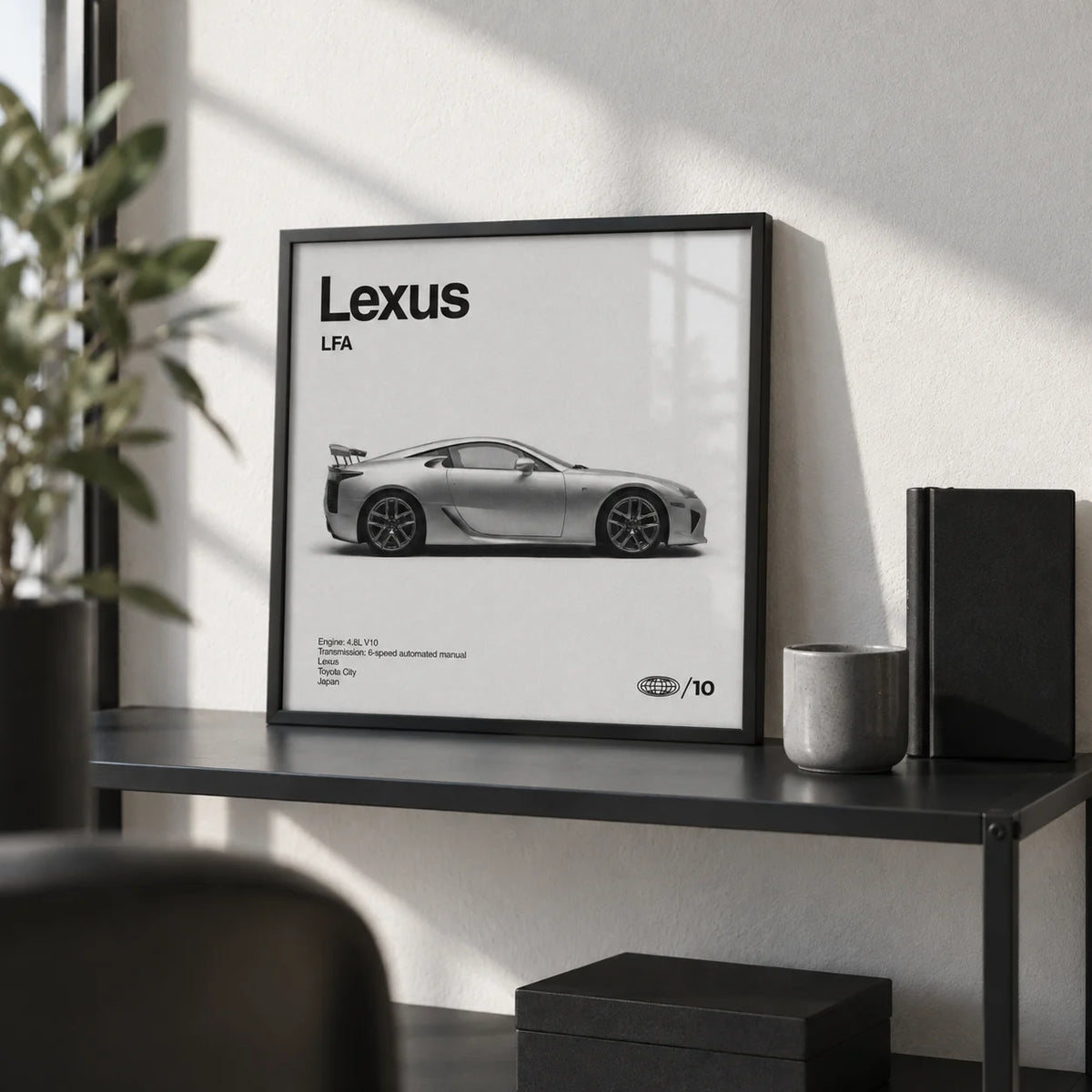 Japanese Supercar Poster, a small A4 framed print leaning on a black metal shelf in a living room