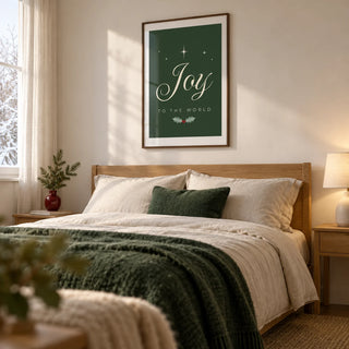Joy to the World Print, framed on the wall of a calm winter bedroom in a UK couple's home with warm white walls and simple oak furniture