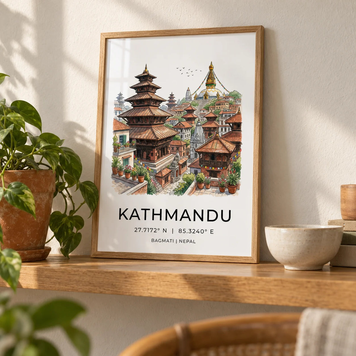 Kathmandu Art Print, a small A4 framed print leaning on a honey-toned oak shelf in a living room
