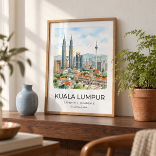 Kuala Lumpur Art Print, a small A4 framed print leaning on a walnut shelf in a living room