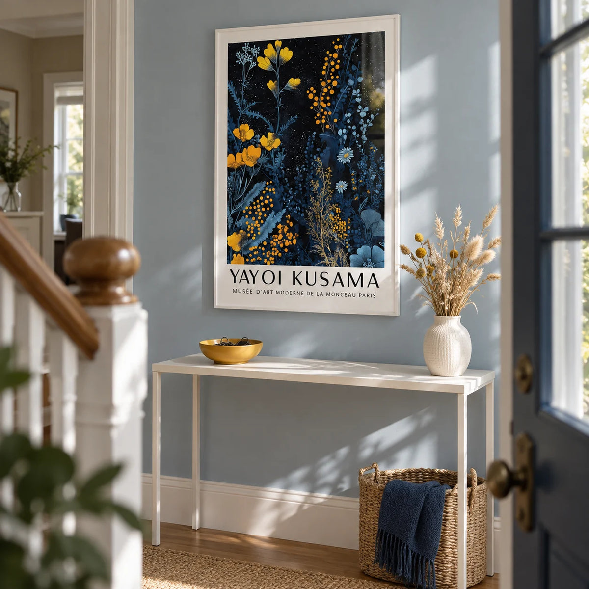 Kusama Museum, framed on the wall of a bright terraced-house hallway with a pale dusty blue wall