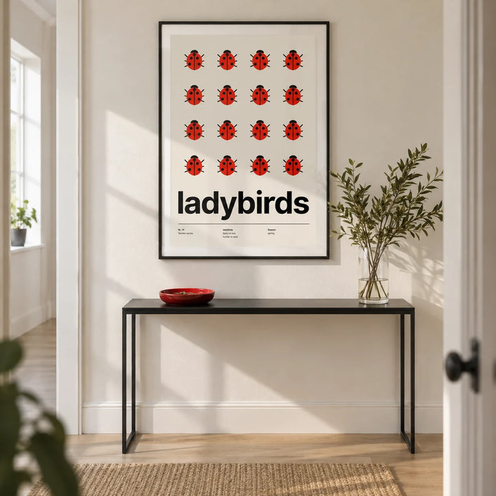 Ladybird Poster, framed on the wall of a crisp modern hallway in a UK first flat (22-28) with an ivory wall and pale oak flooring