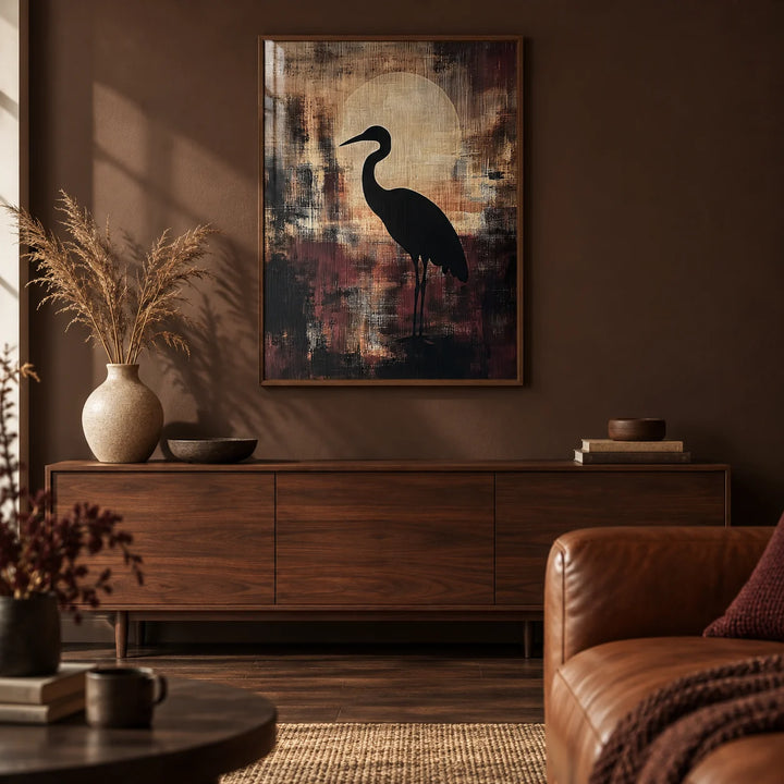 Large Heron Wall Art, framed on the wall of a moody living room with a deep brown painted wall and a dark oak floor
