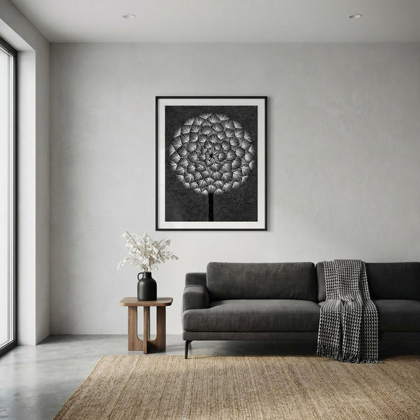 Modern living room with a gray sofa, framed dandelion artwork, and a vase on a small table.