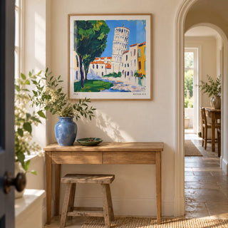 Leaning Tower of Pisa Pictures, framed on the wall of a light hallway in a characterful UK flat with chalky cream walls and a pale stone floor