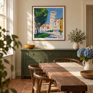 Leaning Tower of Pisa Pictures, framed on the wall of a welcoming dining room in a renovated UK terrace with cream walls and terracotta floor tiles laid without a pattern
