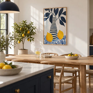 Lemon Art Print, framed on the wall of a open-plan kitchen-diner with navy island units and white walls