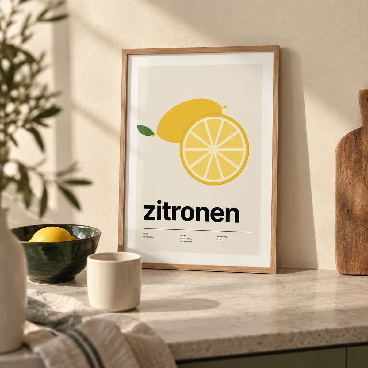 Lemon Slice Print, a small A4 framed print leaning on a pale stone kitchen worktop