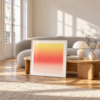 Lemon Sunset Print, framed and leaning against a coffee table in a bright living room