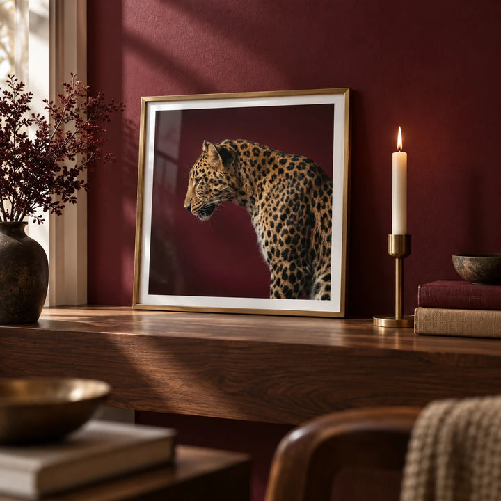 Leopard Art Print, a small A4 framed print leaning on a walnut shelf in a living room
