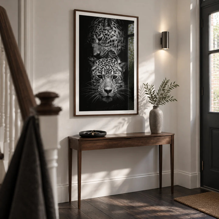 Leopard Photography Print, framed on the wall of a narrow entrance hallway in a renovated UK terrace with a chalk-white wall and dark timber floor