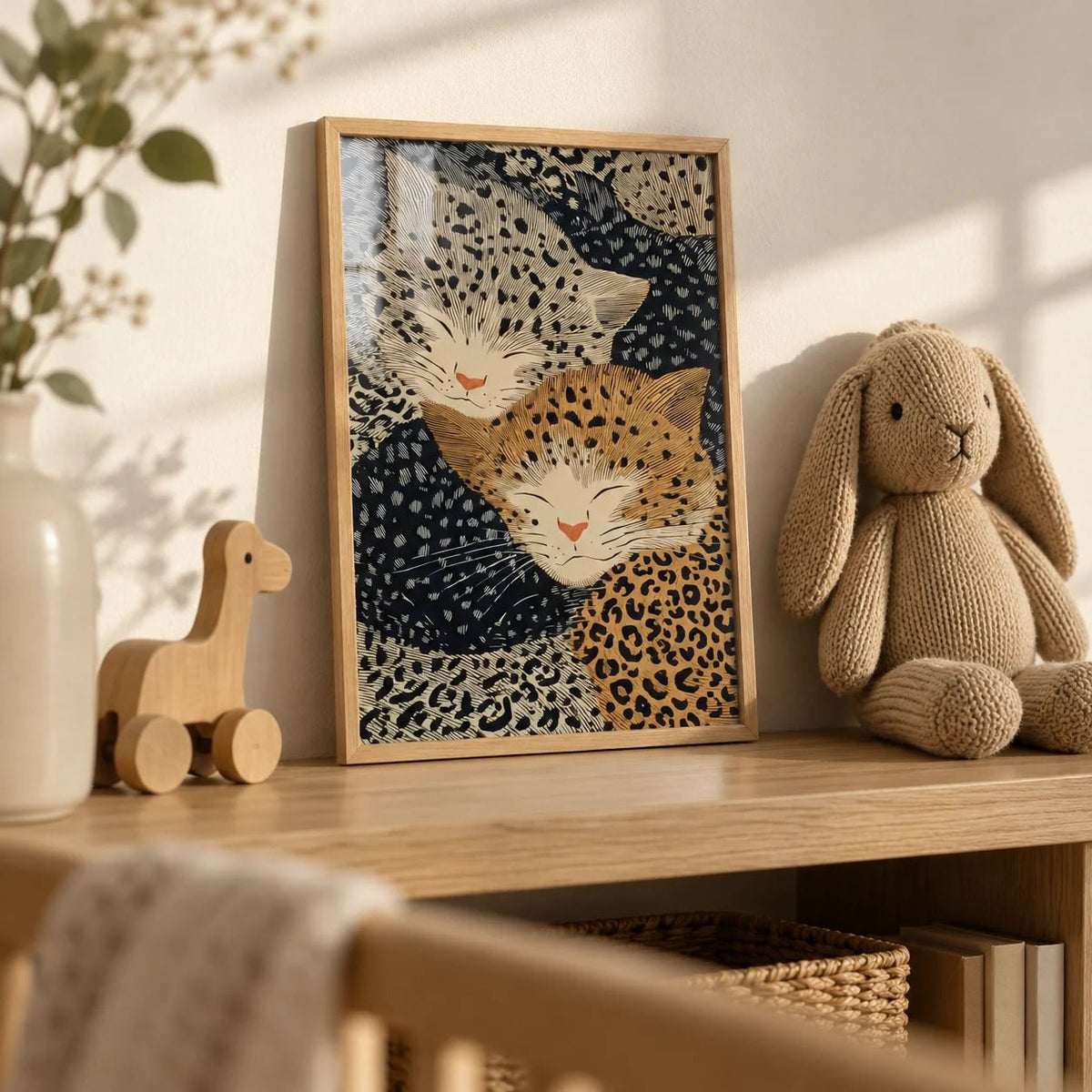 Leopard Print Wall Art, a small A4 framed print leaning on an oak nursery shelf