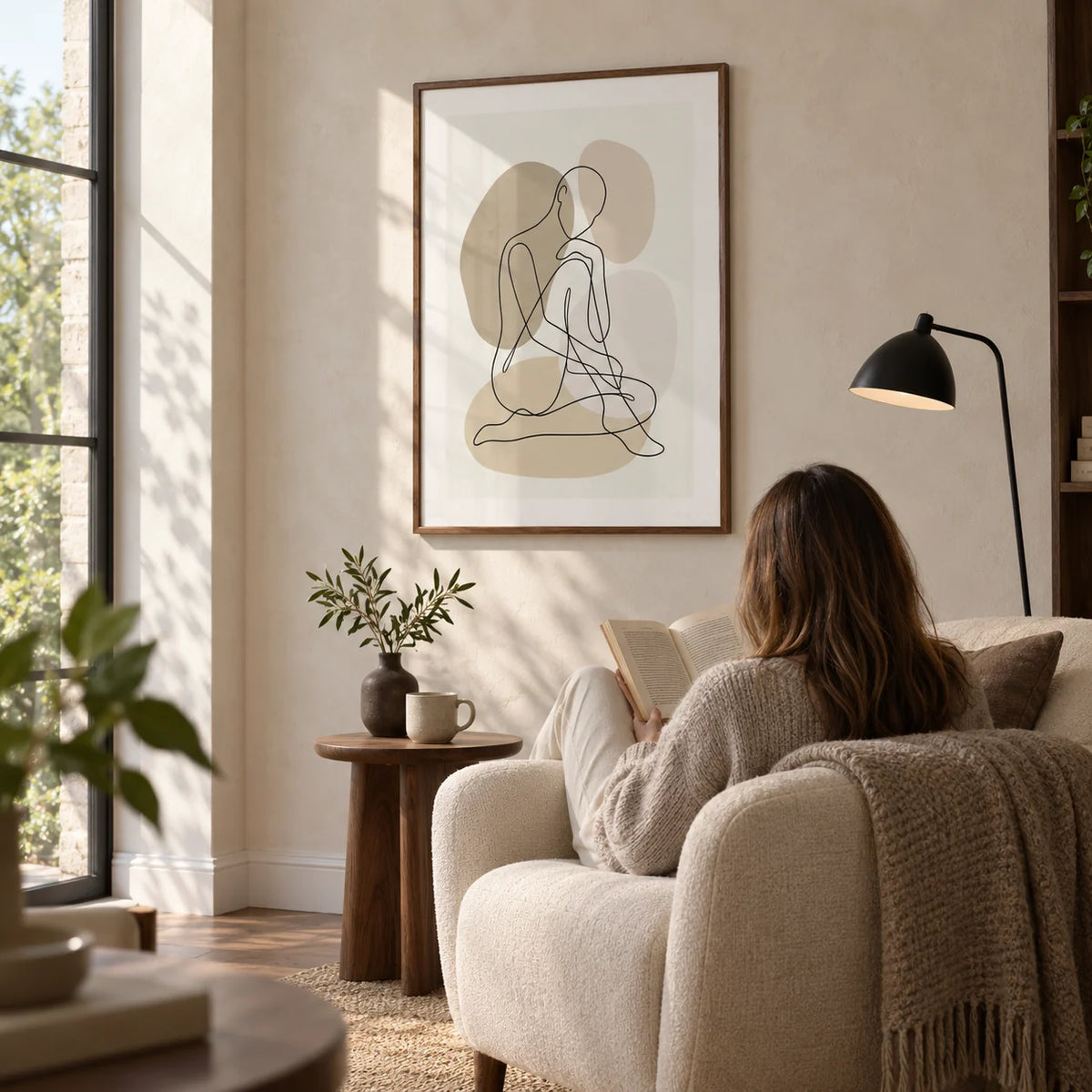 Line Art Figure Print, framed on the wall of a quiet reading corner beside a tall window in a design-conscious UK home with a pale plaster wall in a living room