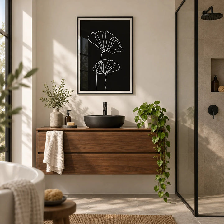 Line Art Floral Print, framed on the wall of a modern bathroom with warm white walls and a black-framed walk-in shower