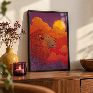 Lion Sunset Art Print, a small A4 framed print leaning on a walnut sideboard in a living room