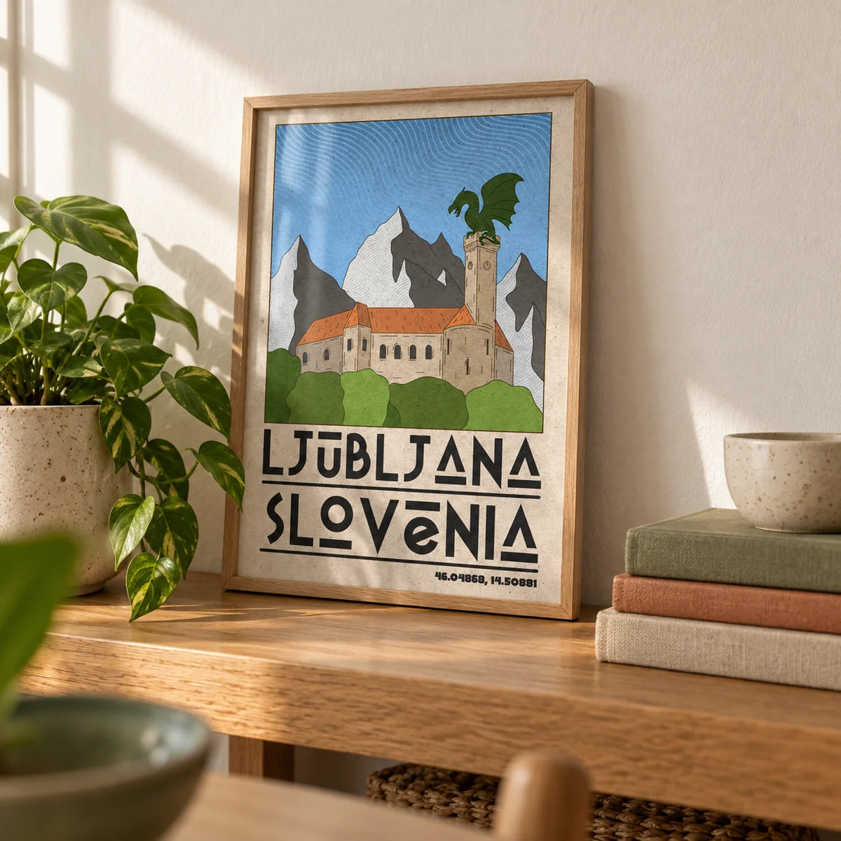 Ljubljana Slovenia Art Print, a small A4 framed print leaning on an oak shelf in a living room