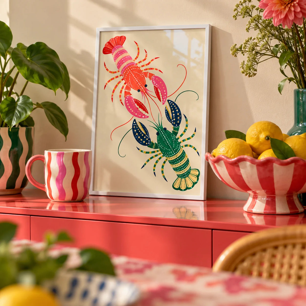 Lobster Wall Art, a small A4 framed print leaning on a colourful lacquered shelf in a living room