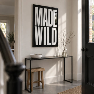 Made Wild Art Print, framed on the wall of a narrow entrance hallway in a renovated UK terrace with white walls and a smooth grey floor