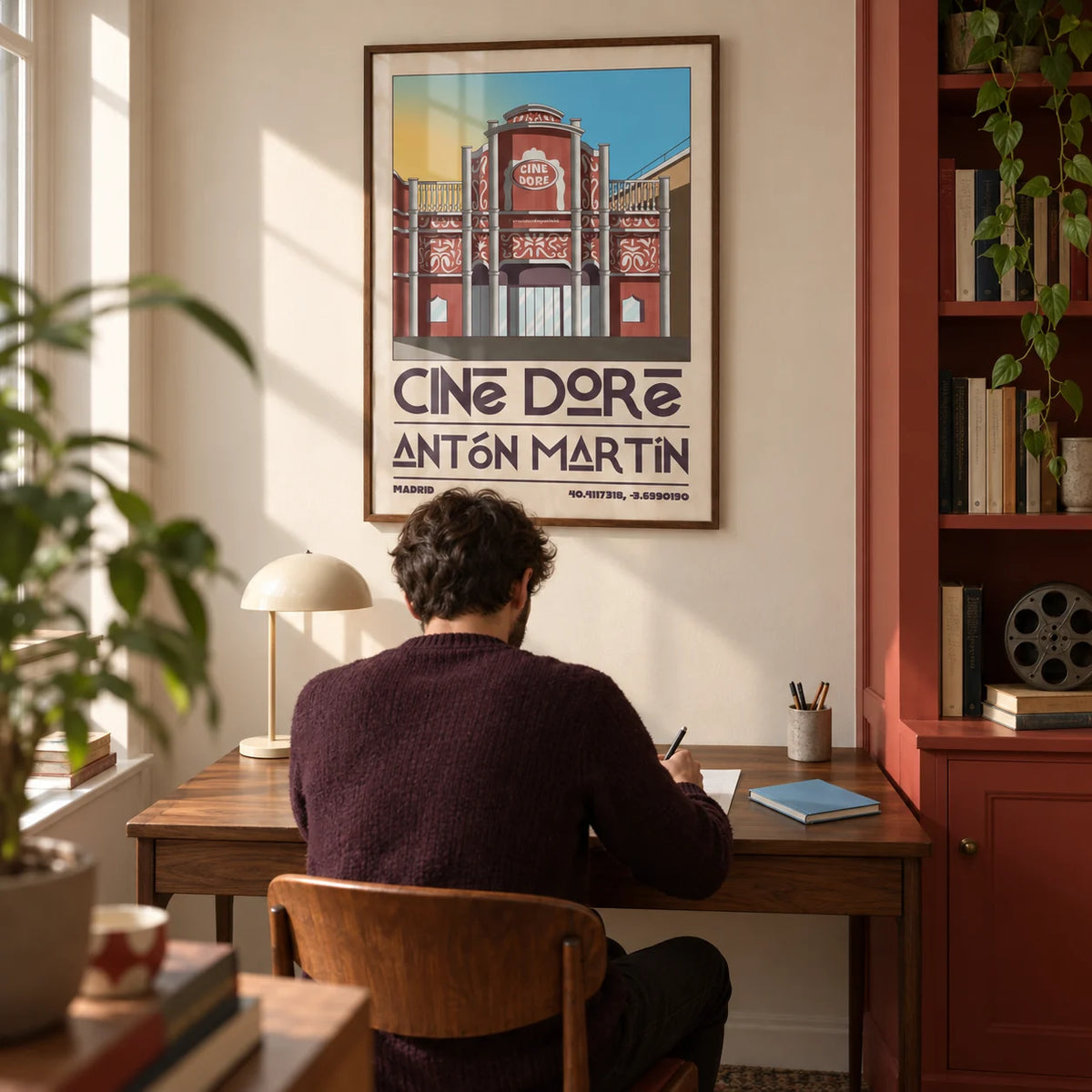 Madrid Landmark Poster, framed on the wall of a compact home study for a cinema enthusiast in a converted UK terrace with a cream wall and a built-in brick-red cupboard